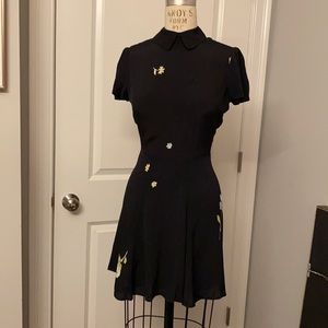 Reformation dress with collar and puff sleeves. Black with flower print.